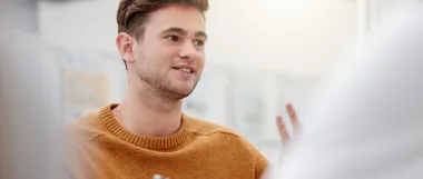 A man discussing with another man in an office.